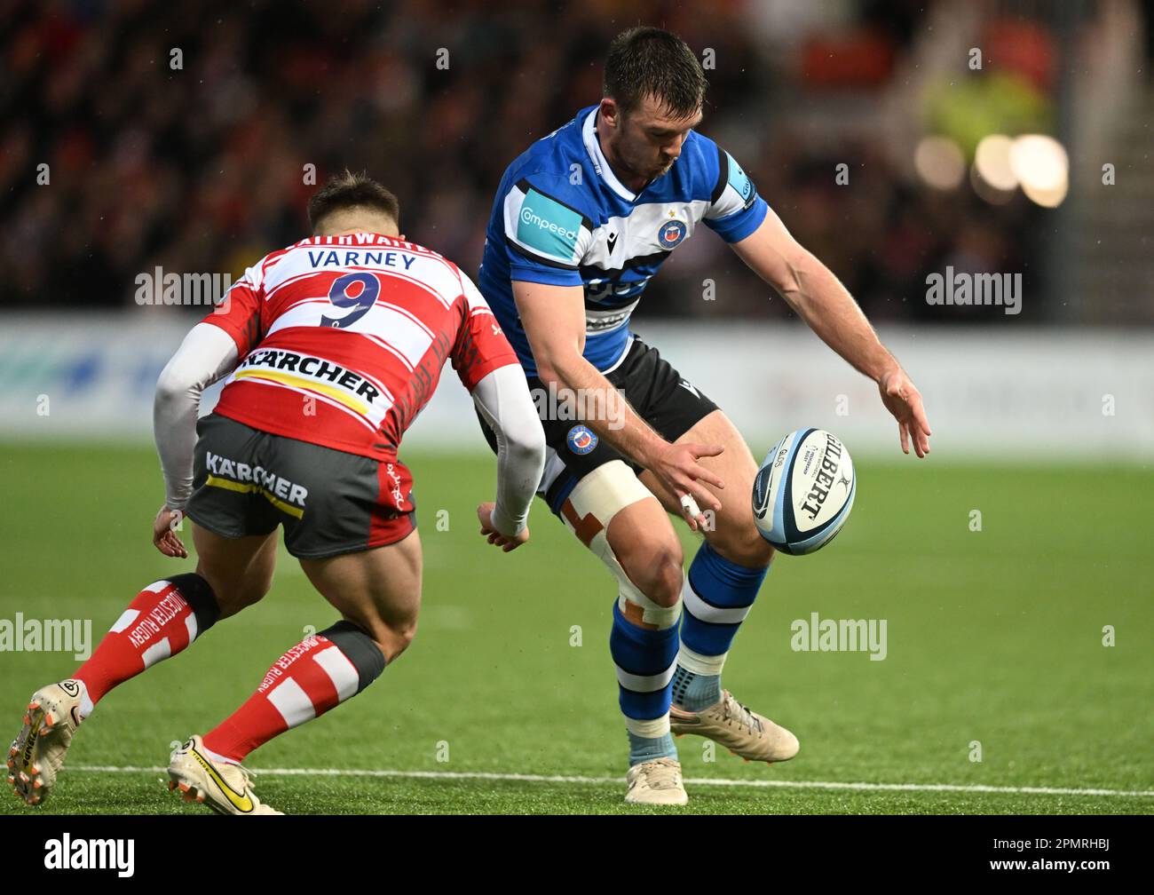 Kingsholm Stadium, Gloucester, Gloucestershire, UK. 14th Apr, 2023. Gallagher Premiership Rugby, Gloucester versus Bath; Matt Gallagher of Bath chips the ball forward under pressure from Steven Varney of Gloucester Credit: Action Plus Sports/Alamy Live News Stock Photo