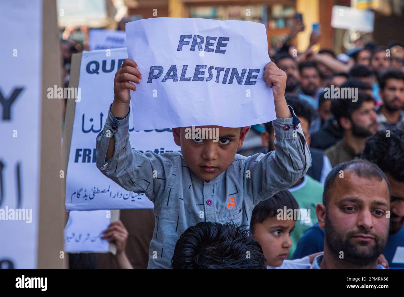 A Kashmiri Muslim kid holds a placard during a rally marking al-Quds ...