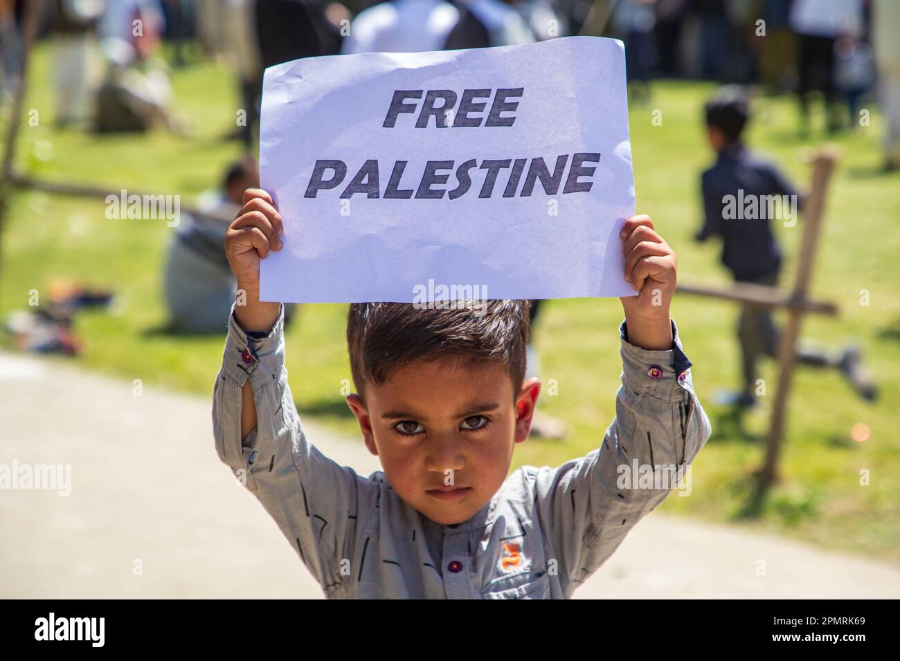 A Kashmiri Muslim kid holds a placard during a rally marking al-Quds ...