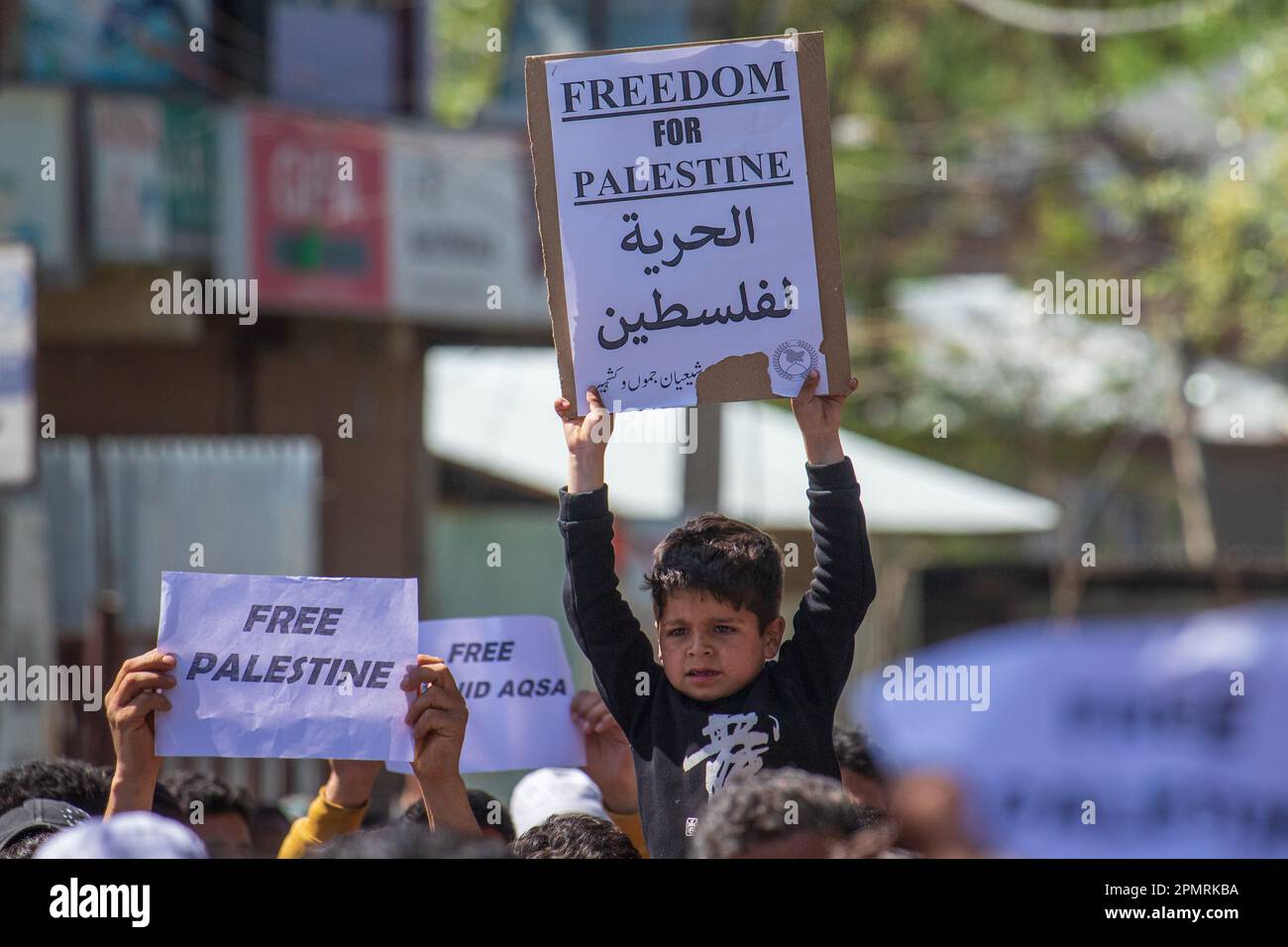 A Kashmiri Muslim kid holds a placard during a rally marking al-Quds ...