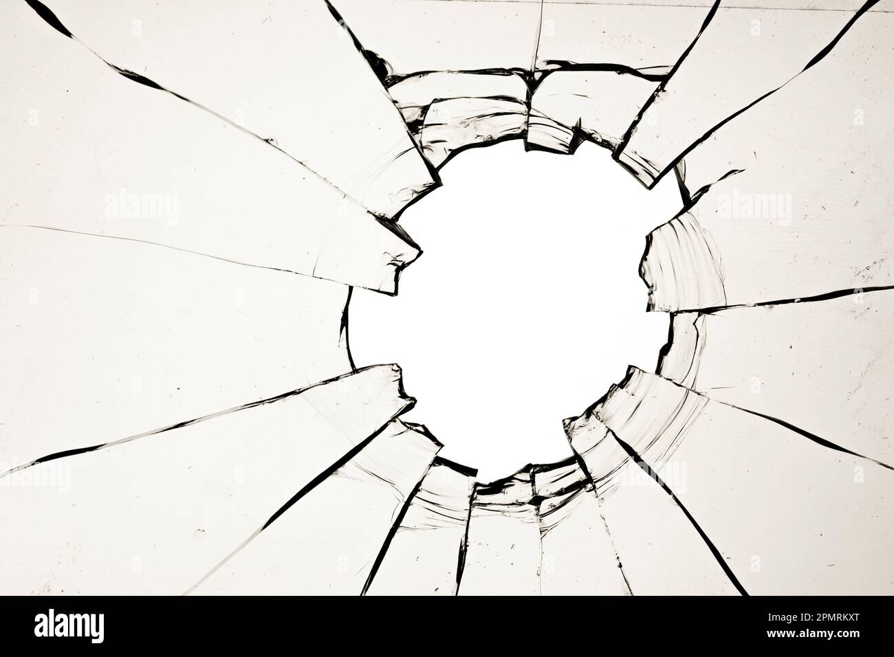 A hole in the window, cracks in the glass. The effect of a broken window texture on a white background Stock Photo