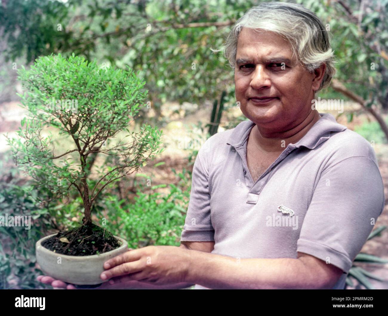 An old man holding a bonsai tree at Coimbatore, Tamil Nadu, South India