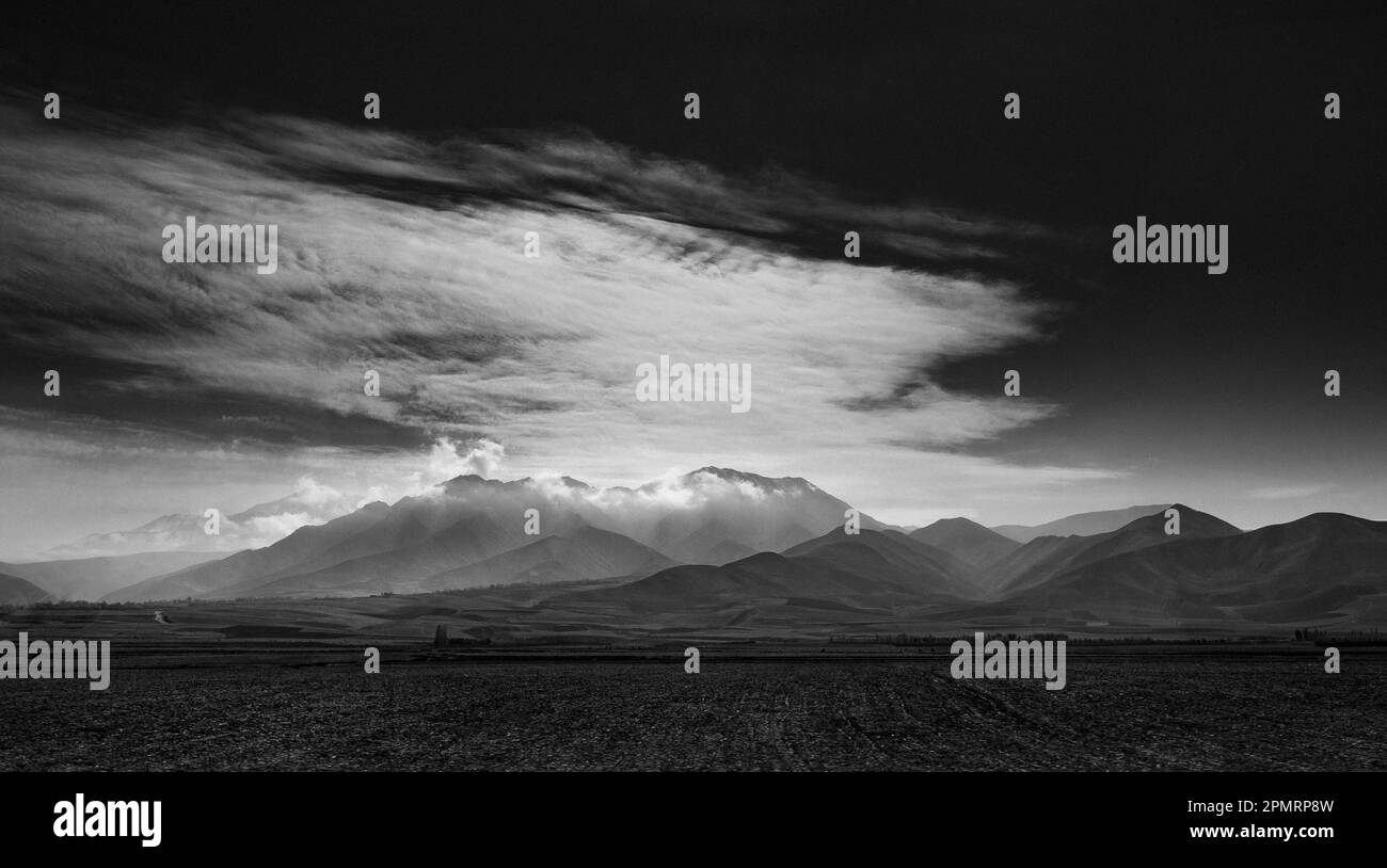 A black and white photo of a beautiful landscape with mountains and clouds; Takhar, Afghanistan Stock Photo