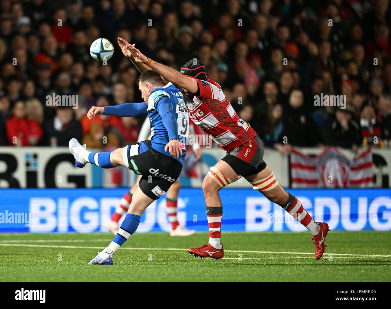 Kingsholm Stadium, Gloucester, Gloucestershire, UK. 14th Apr, 2023. Gallagher Premiership Rugby, Gloucester versus Bath; Ben Spencer of Bath kicks from the base of the ruck under pressure from Matias Alemanno of Gloucester Credit: Action Plus Sports/Alamy Live News Stock Photo