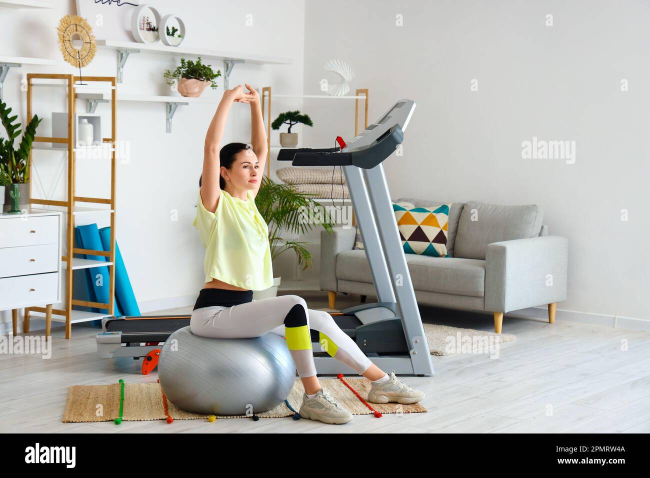 Beautiful woman training on fitball at home Stock Photo - Alamy