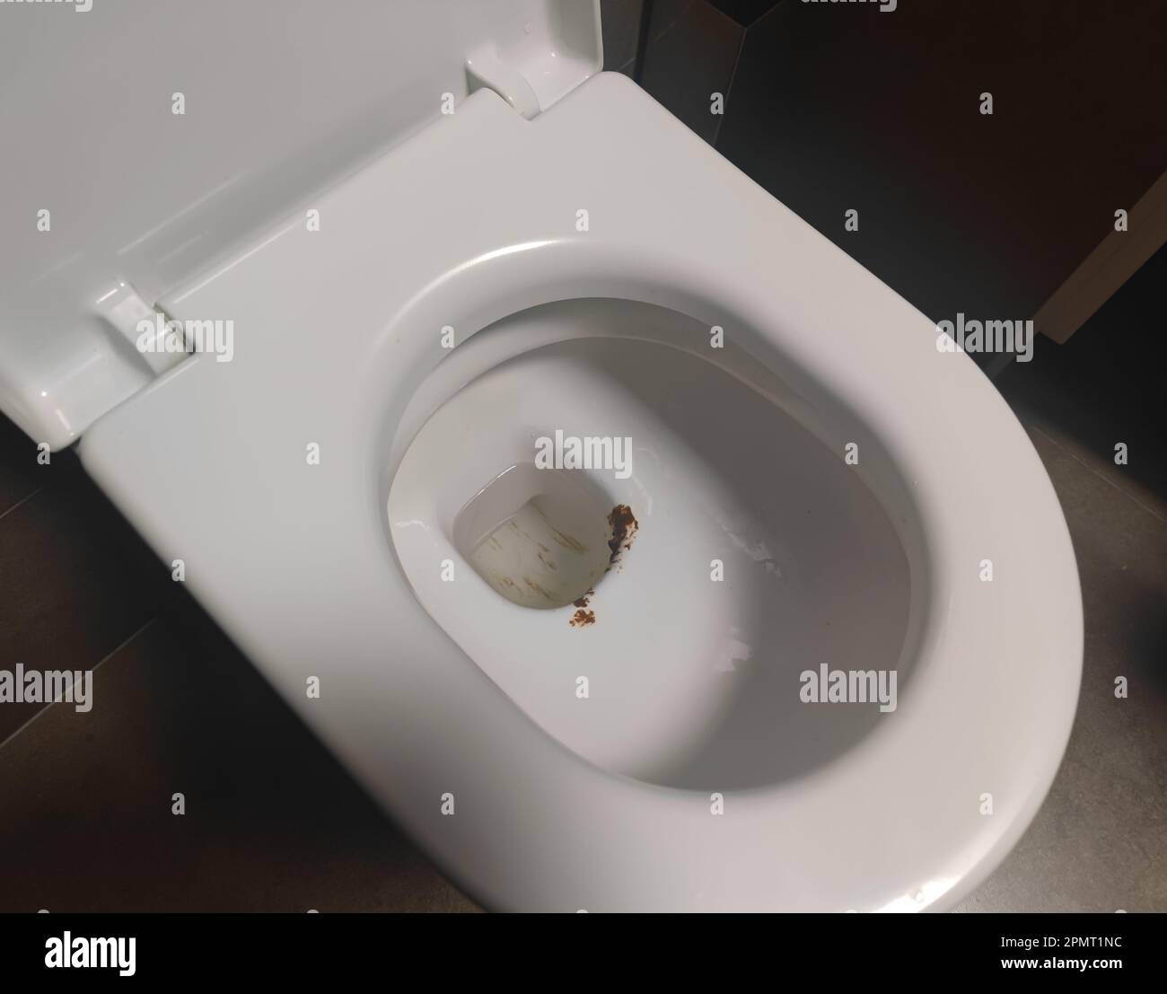 Dirty toilet bowl with unflushed water. Unhygienic, unclean and unpleasant toilet before