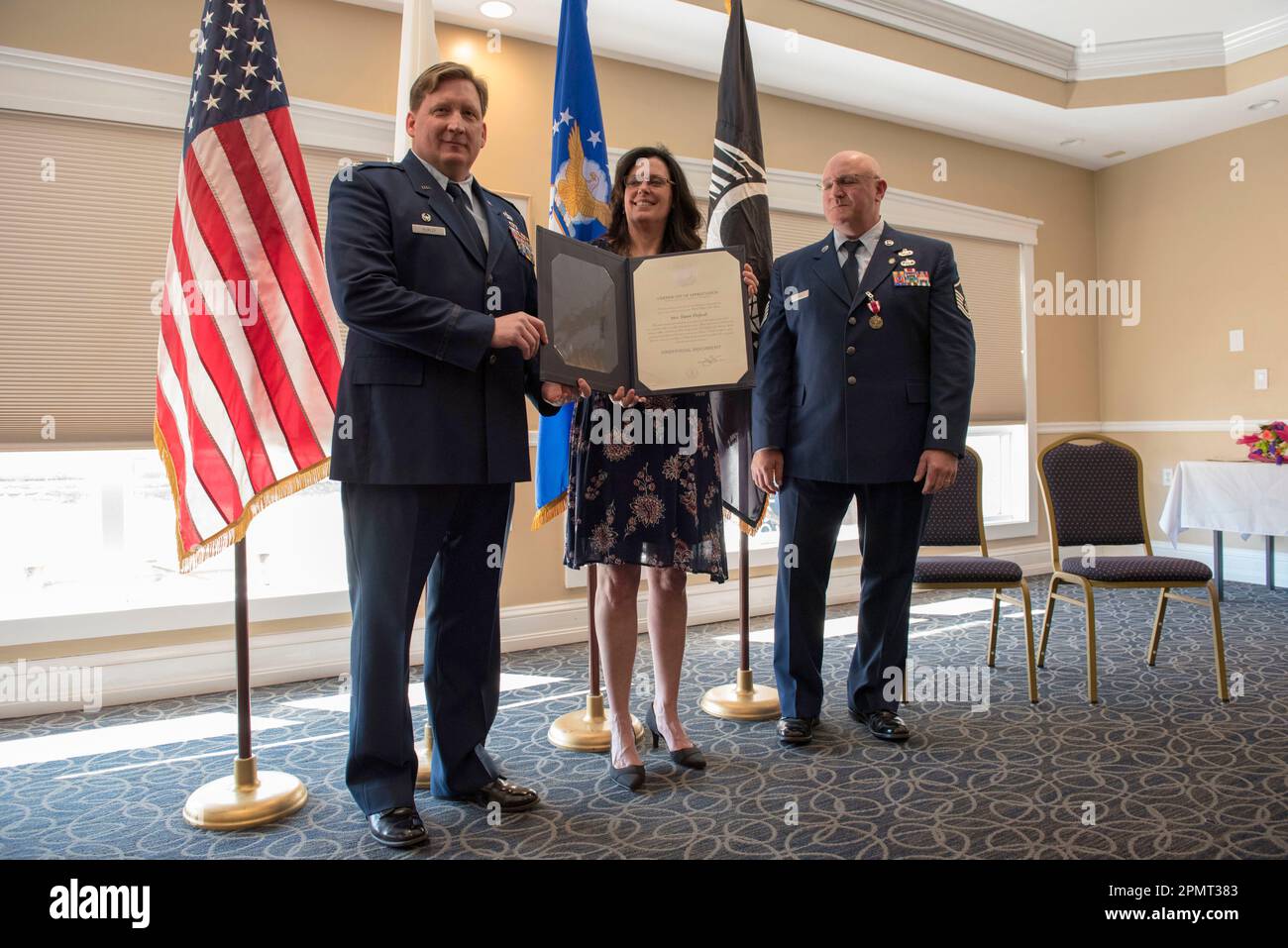 Cape Cod, Massachusetts, USA. 14th Apr, 2023. Jack Teixeira's mom, DAWN DUFAULT, center, attends the retirement ceremony of Teixeira's stepdad Master Sgt. THOMAS P. DUFAULT, left, who retired from the 102nd Intelligence Wing after 34 years of honorable service at a ceremony held on April 6, 2019, at Joint Base Cape Cod. (Credit Image: © Staff Sgt. Thomas Swanson/ZUMA Press Wire) EDITORIAL USAGE ONLY! Not for Commercial USAGE! Stock Photo