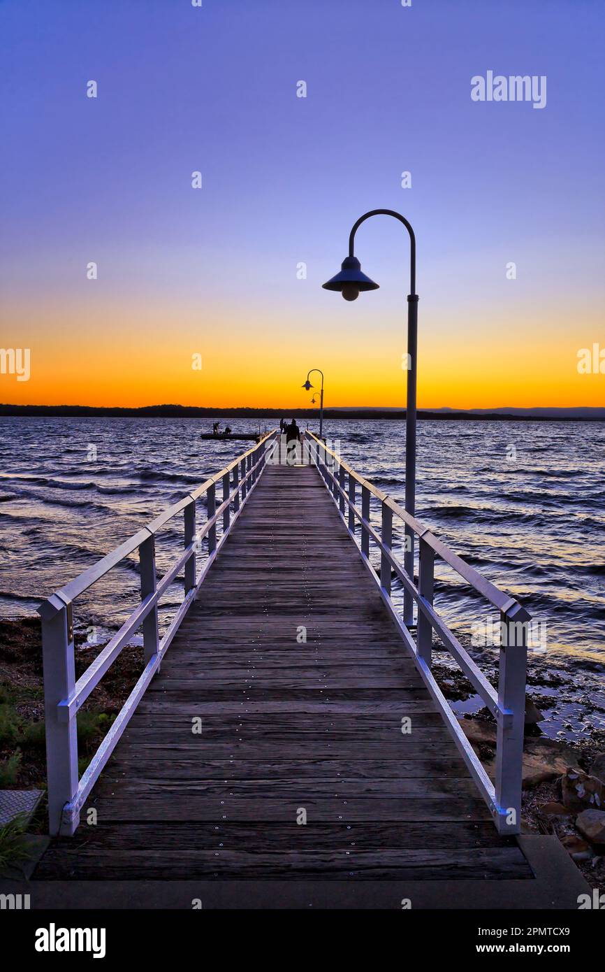 Long timber jetty off town beach in Murrays beach on Lake Macquarie in