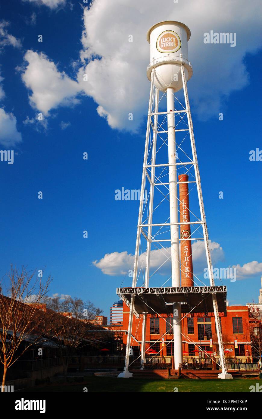 A large water tower, bearing the brand of a cigarette company, is a reminder of the tobacco processing plant that was once prevalent in Durham, NC Stock Photo