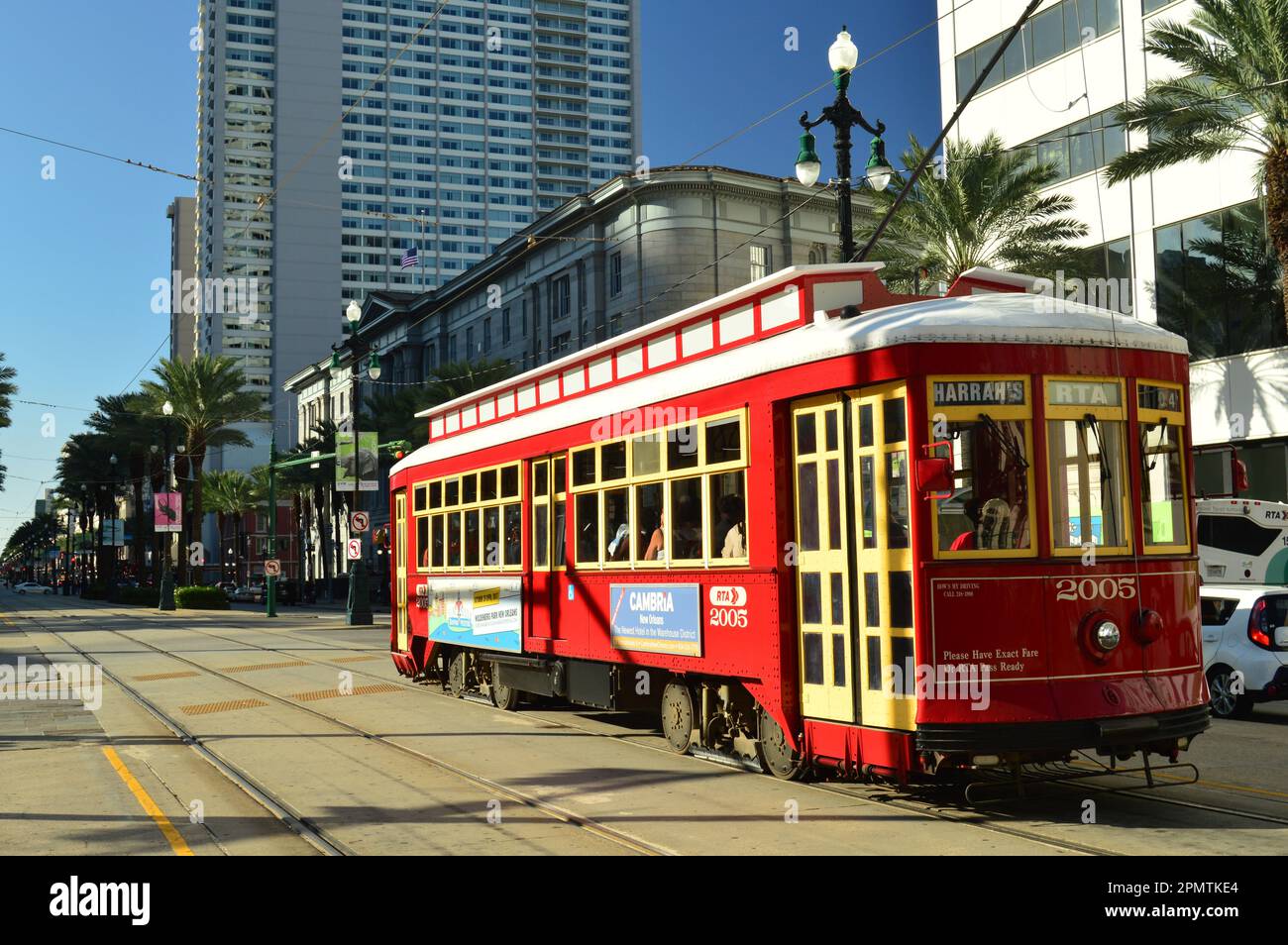 A historic red streetcar travels though the downtown New Orleans, along Canal Street, providing public transportation for the city Stock Photo