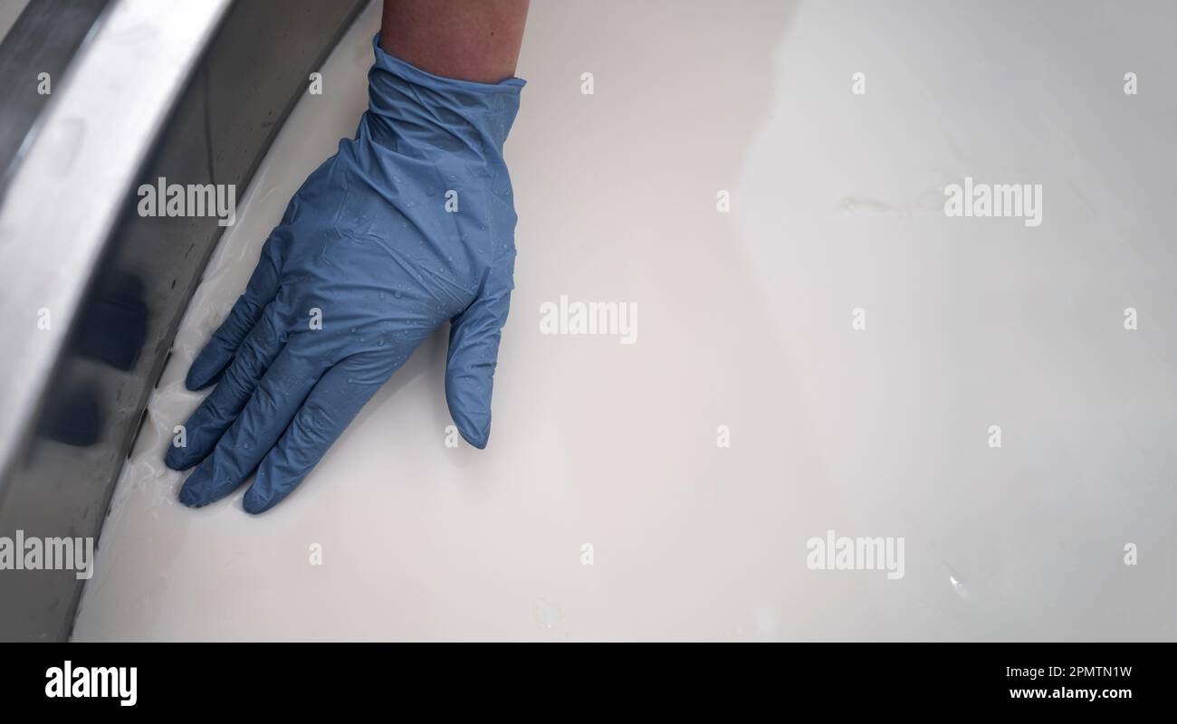 Cheesemaker testing ready of milk in a steel container with a hands ...