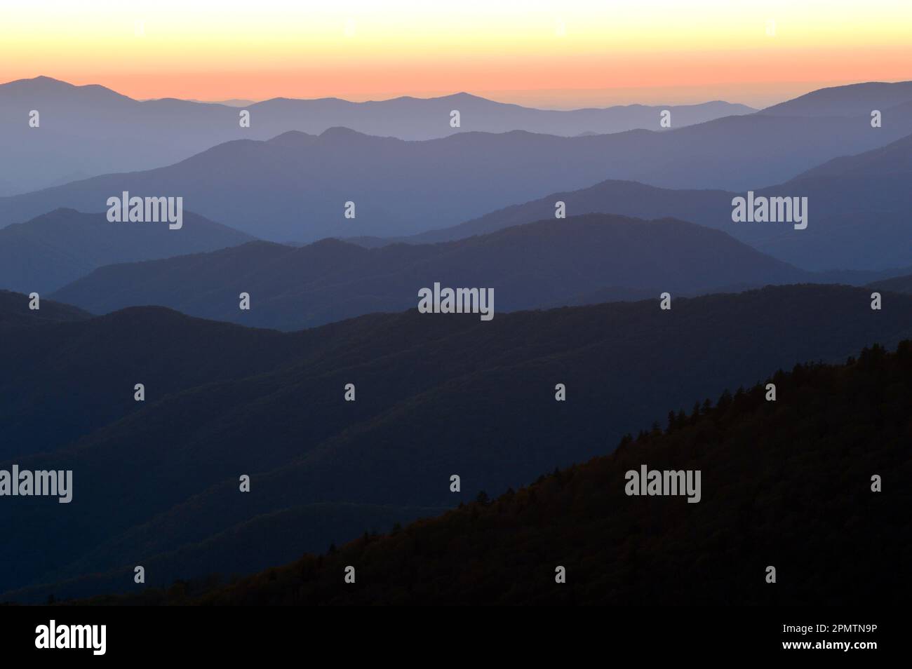 Sunset glow renders the layers of the Great Smokey Mountains in various shades and colors as is extends to the horizon Stock Photo