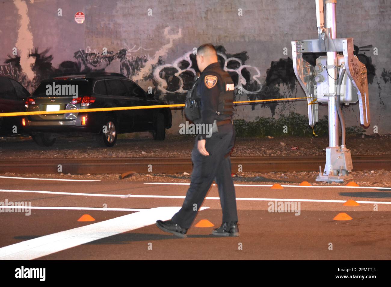 Paterson, USA. 14th Apr, 2023. An officer walk by evidence markers