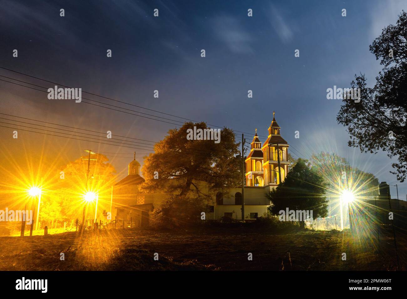 A Church at night with a light. San Miguel de las Casitas Xichu Guanajuato Mexico Stock Photo
