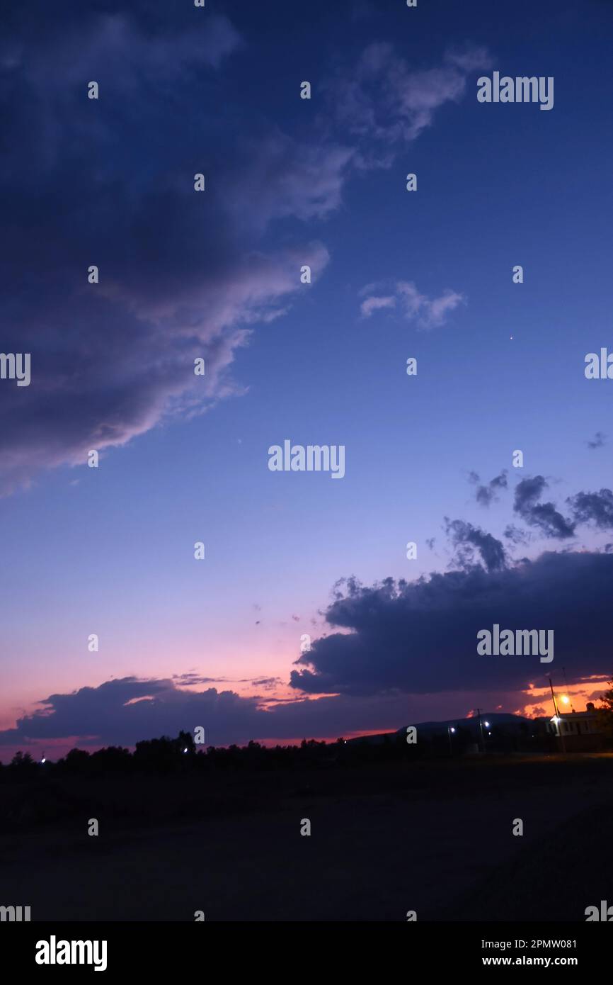 A blue sky with a few clouds in it Stock Photo