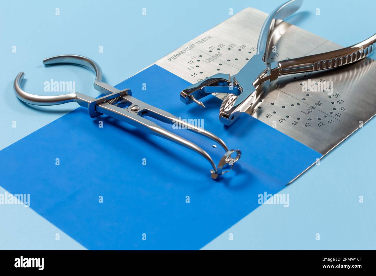Dental hole punch, the rubber dam forceps and the metal plate Stock