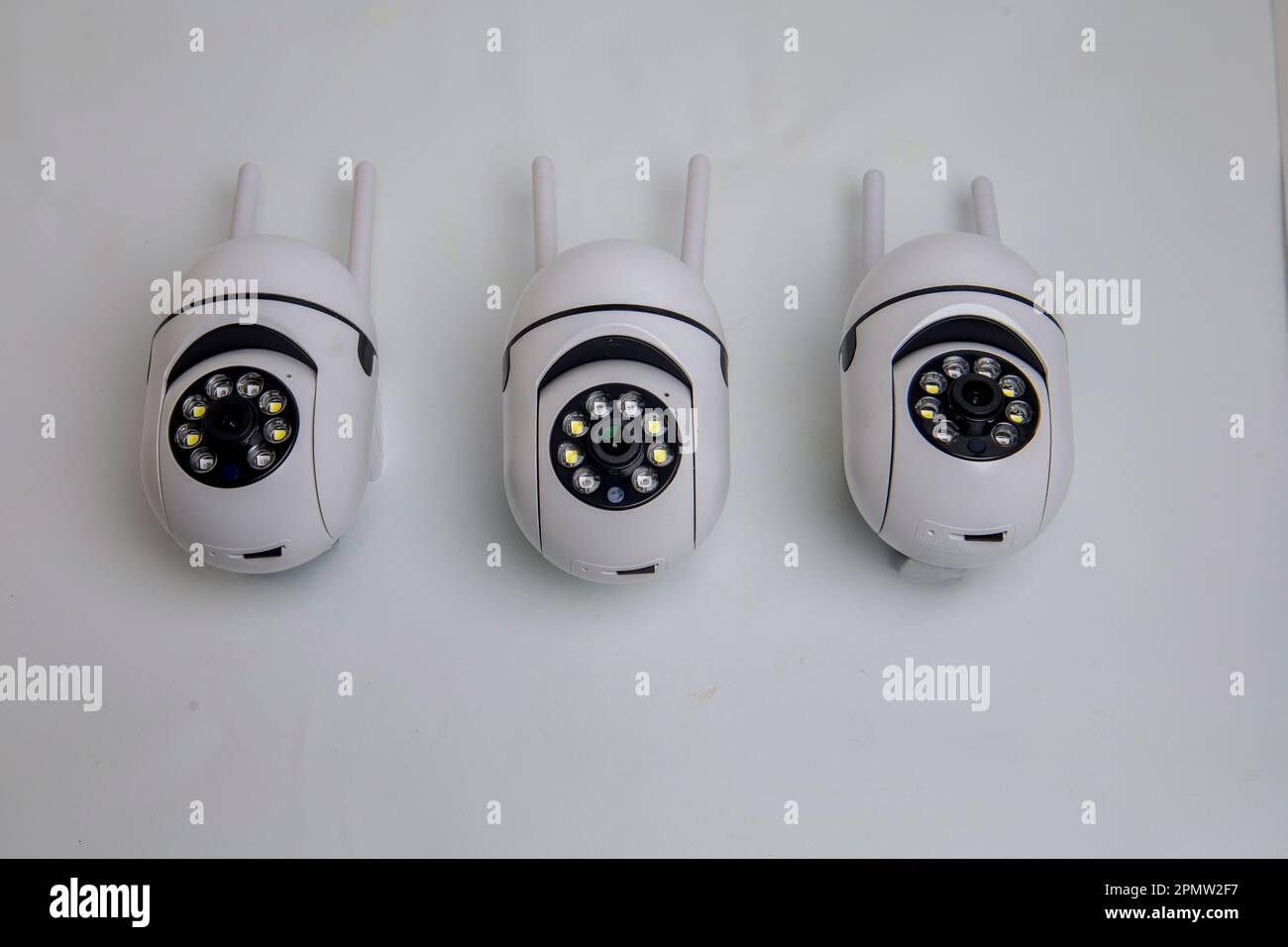 Rotating video surveillance camera on a white background. Stock Photo