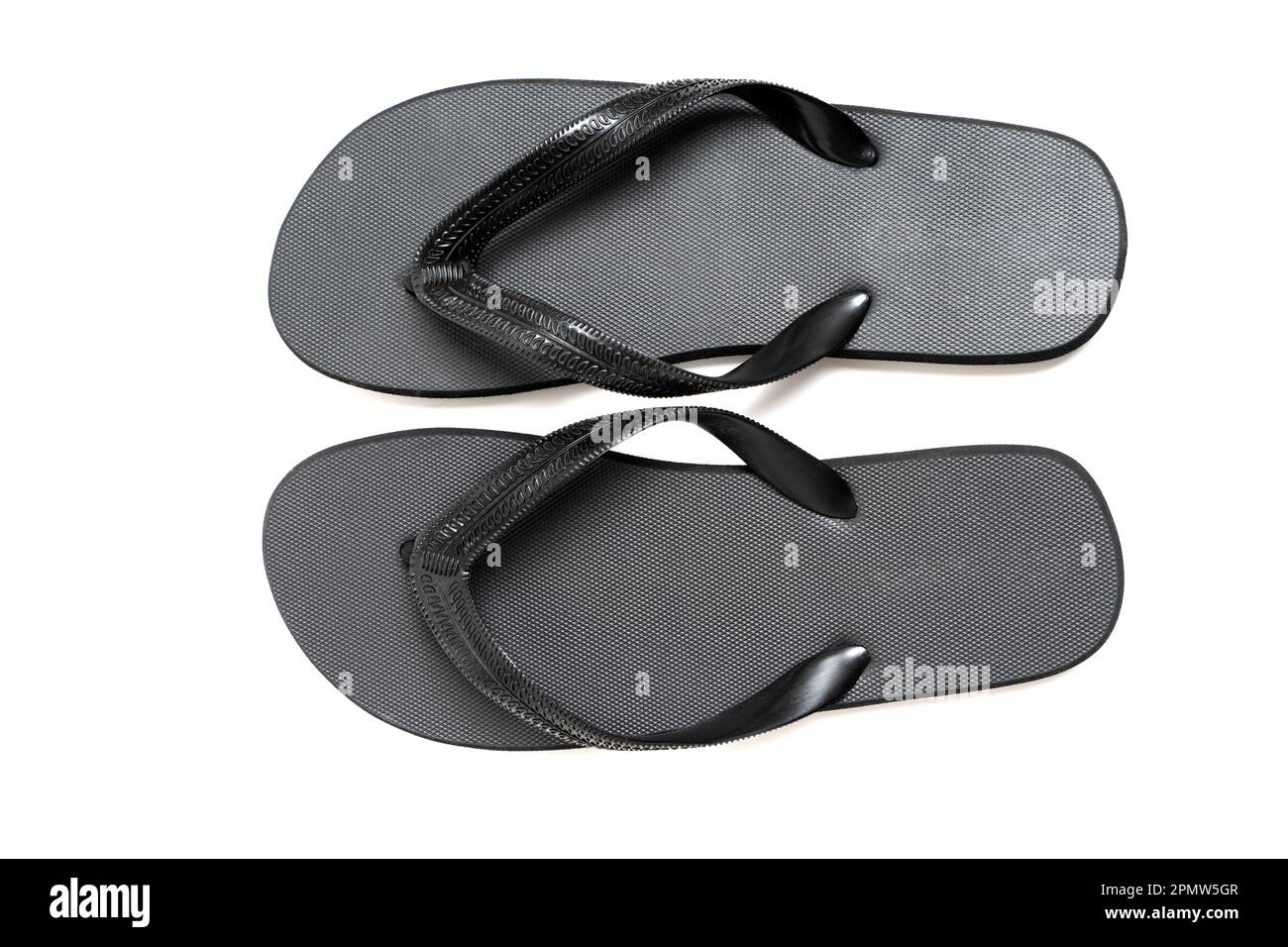 High angle closeup of black flip flops with textured straps and a