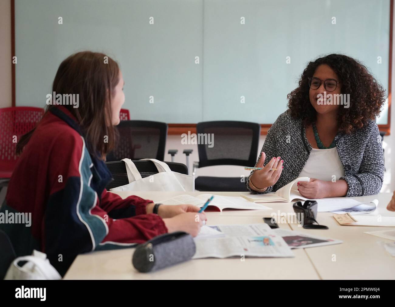 (230415) -- BEIJING, April 15, 2023 (Xinhua) -- Rafaela (R) and Maria talk at a classroom at the Yenching Academy of Peking University in Beijing, capital of China, March 31, 2023. Maria Eduarda Variani, Rafaela Viana dos Santos, Manuela Boiteux Pestana, and Marco Andre Rocha Germano are Brazilian students studying in the Master of China Studies program at the Yenching Academy of Peking University in China. The four of them have been interested in Chinese culture since they were young. After arriving in Beijing, they have been impressed by the Chinese capital's profound cultural heritage, Stock Photo