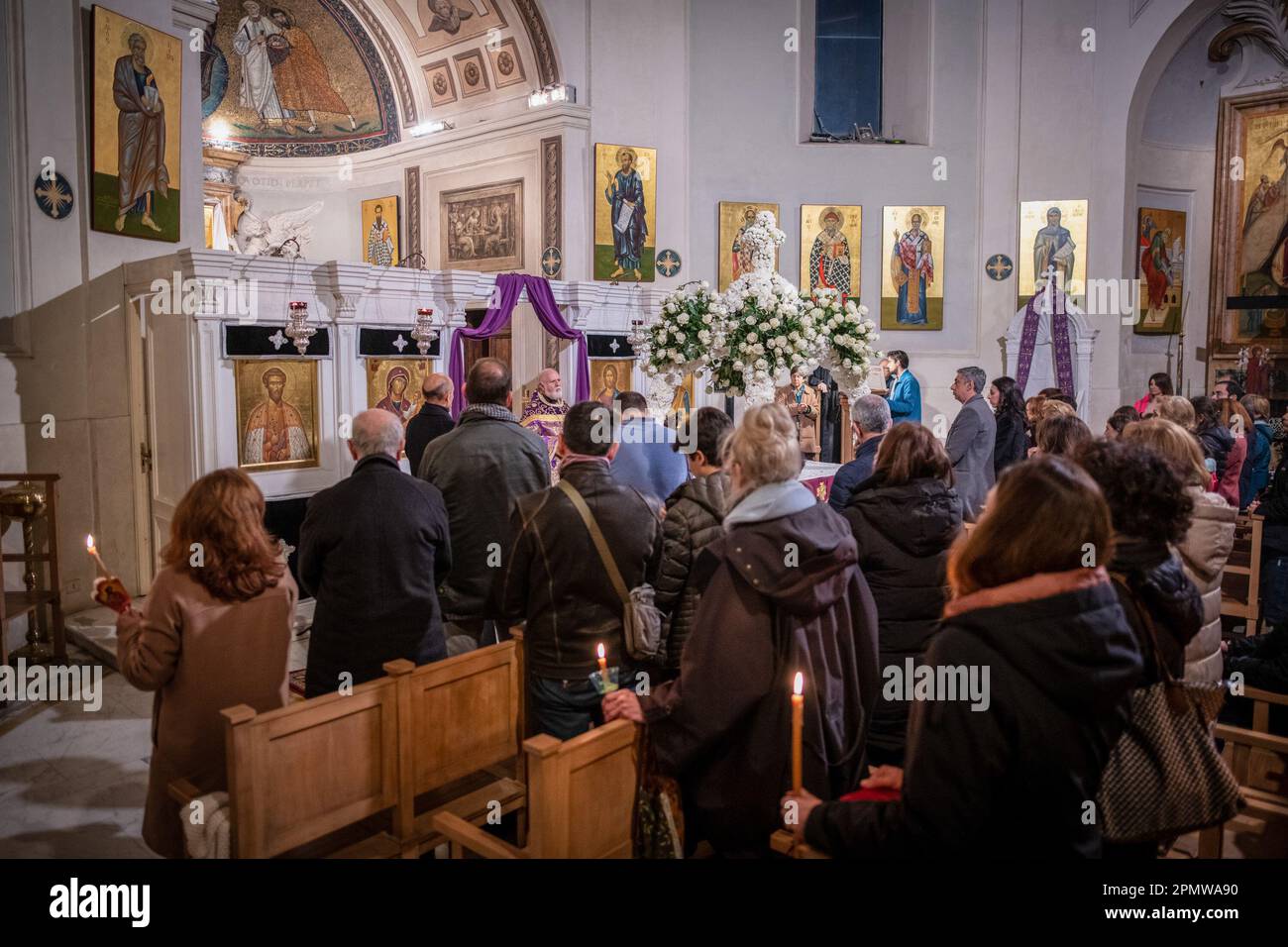 Devotees pray inside the Church of San Teodoro al Palatino on the evening of Good Friday preceding the Orthodox Easter. Orthodox Christians from the Church of San Teodoro al Palatino accompany the representation of the Edicule of the Holy Sepulchre in procession with the Band of Carabinieri. The Greek-Orthodox church of San Teodoro al Palatino was built in the 6th century on the ruins of the Horrea Agrippiana, probably reusing a pre-existing circular temple. Tradition had it that the temple was dedicated to Romulus, and that the Capitoline Wolf was kept here until 1471. (Photo by © Marcello Va Stock Photo