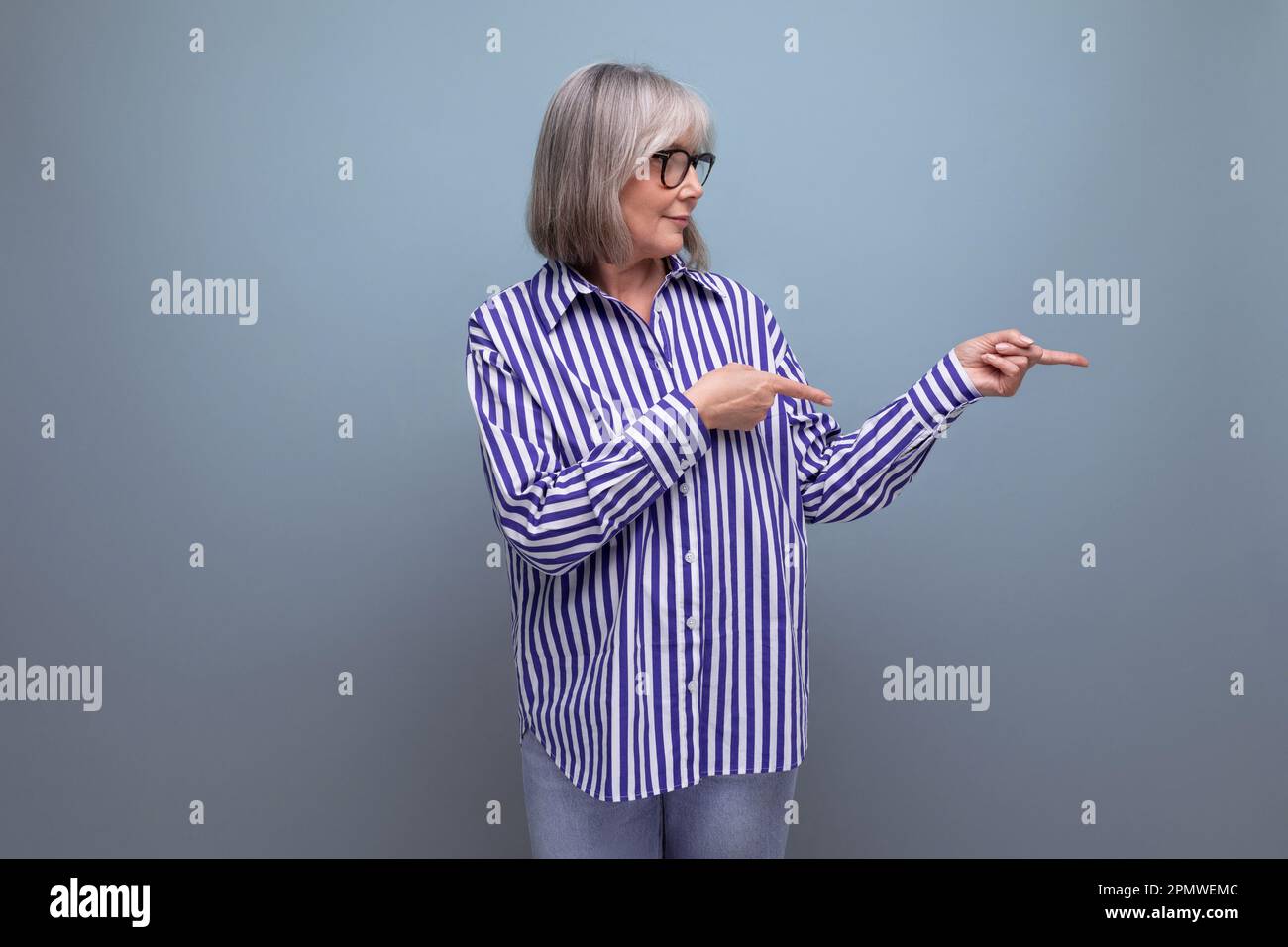 smart stylish mature 60s woman with gray hair on bright studio background with copy space Stock Photo