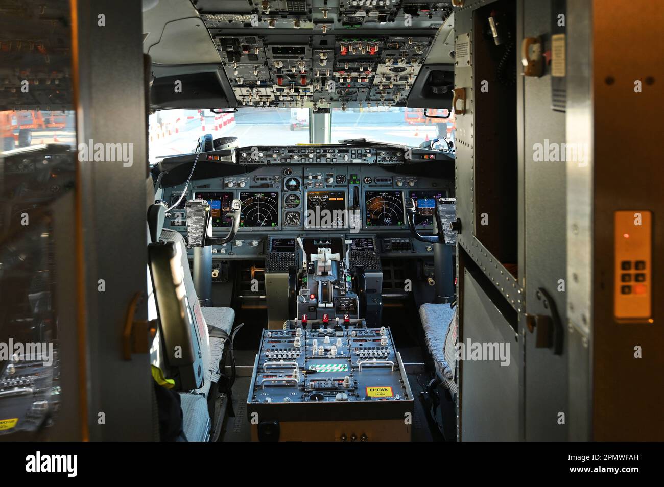 The interior cockpit of the  Boing 737 plane with a variety of large buttons and controls Stock Photo