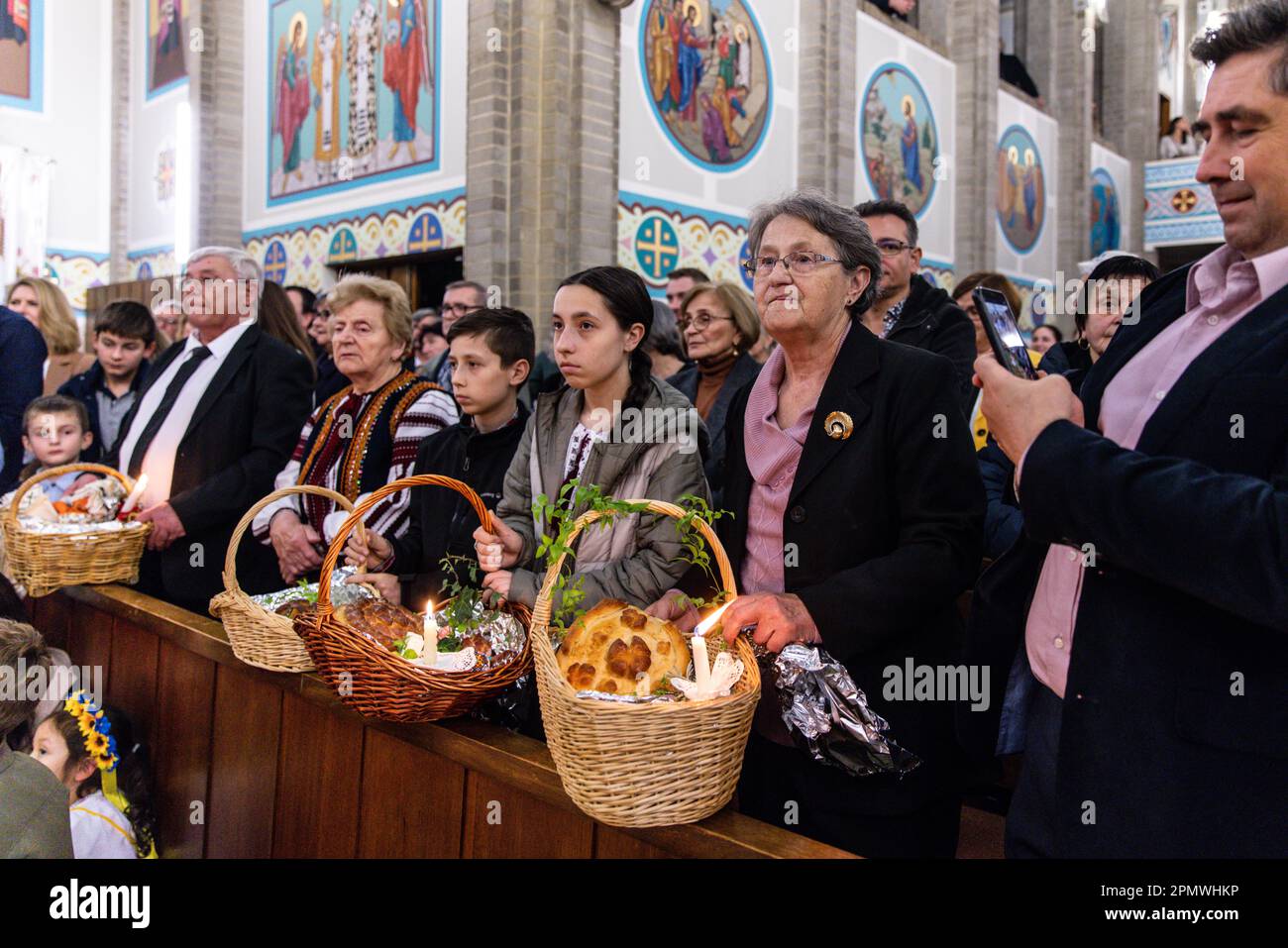 Ukrainian worshippers bring baskets with food to be blessed during a Ukrainian Catholic Easter
