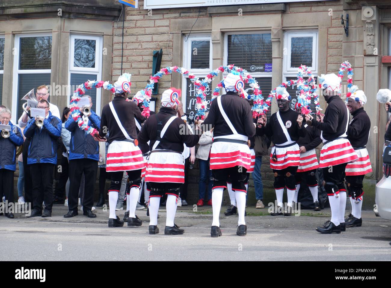 The Britannia Coconutters perform their annual perambulation of the town of Bacup in Lancashire outside the George & Dragon pub on Easter Saturday Stock Photo