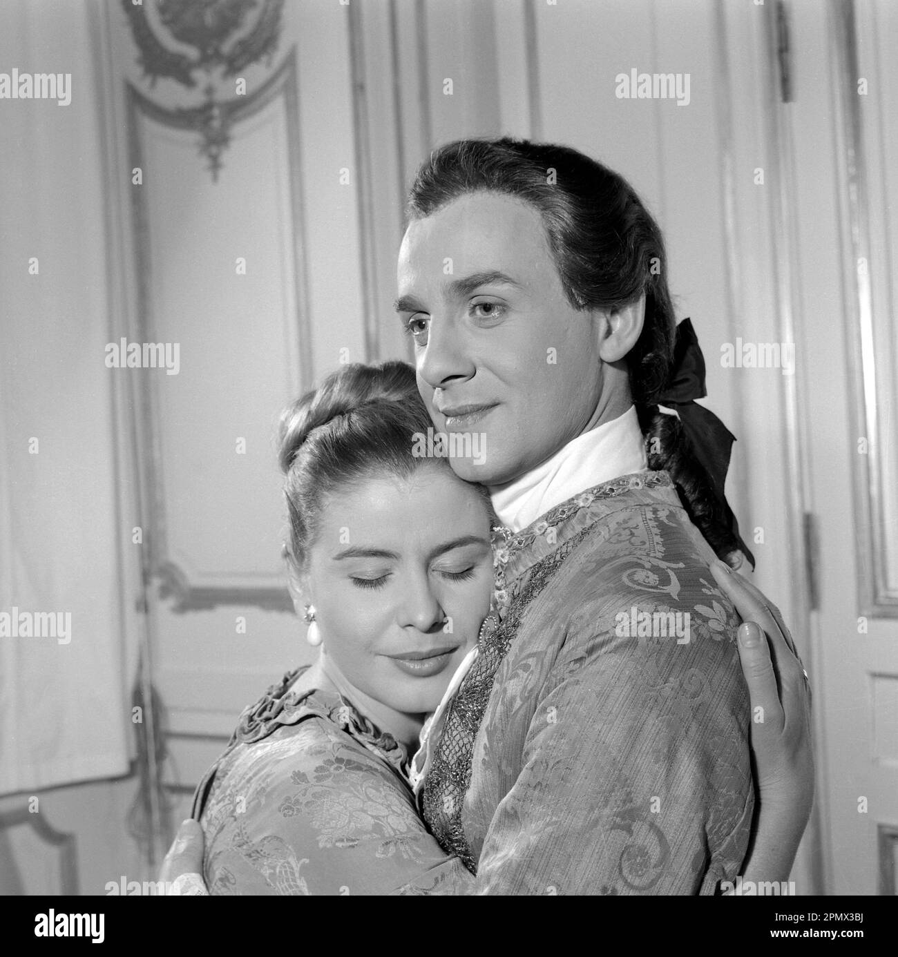 As if in the 18th century. Actors Jarl Kulle and Maj-Britt Nilsson in a scene taken inside the royal castle Drottningholm in Stockholm. The photograph was originally published to illustrate a historic novel running in several episodes in a magazine 1956. The room, furniture and clothing are typical of the 18th century Sweden. Conard ref EC3168 Stock Photo