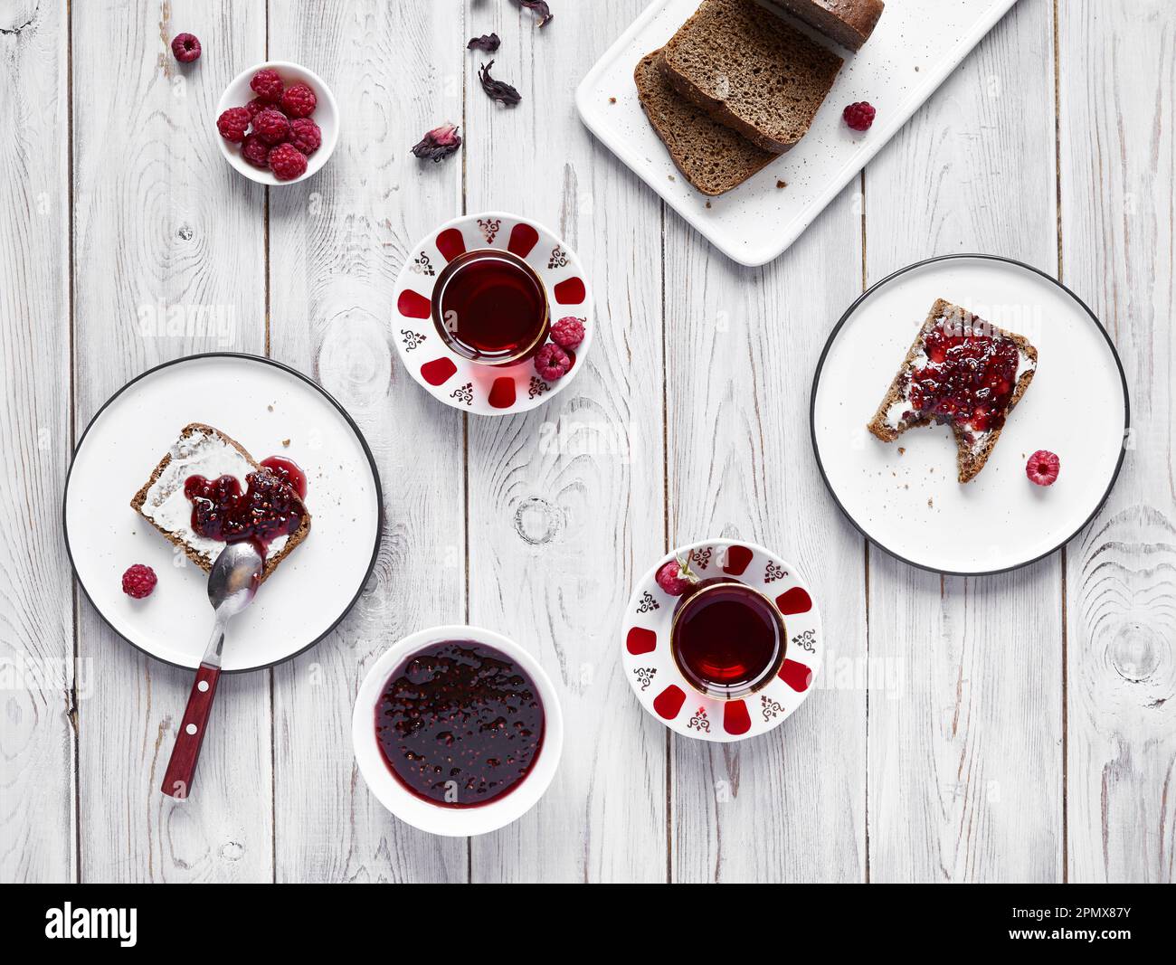 Turkish tea and bread with butter and raspberries jam in white table at breakfast in Istanbul