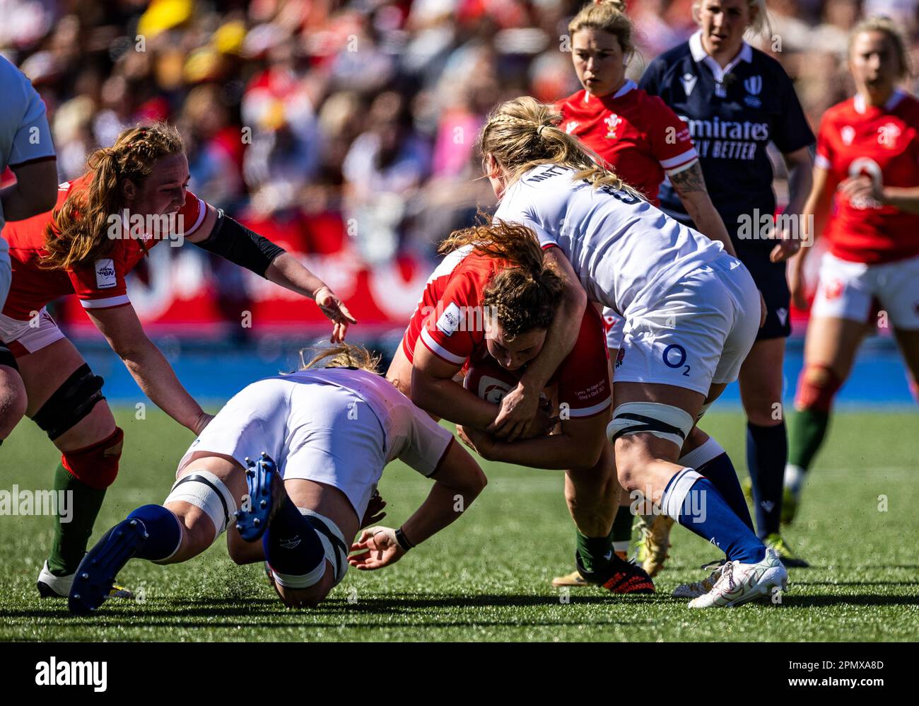 Wales Gwenllian Pyrs is tackled by England's Sarah Beckett (left) and Alex Matthews (right) during the third round of the TikTok Women's Six Nations, Cardiff Arms Park, Cardiff. Picture date: Saturday April 15, 2023. Stock Photo