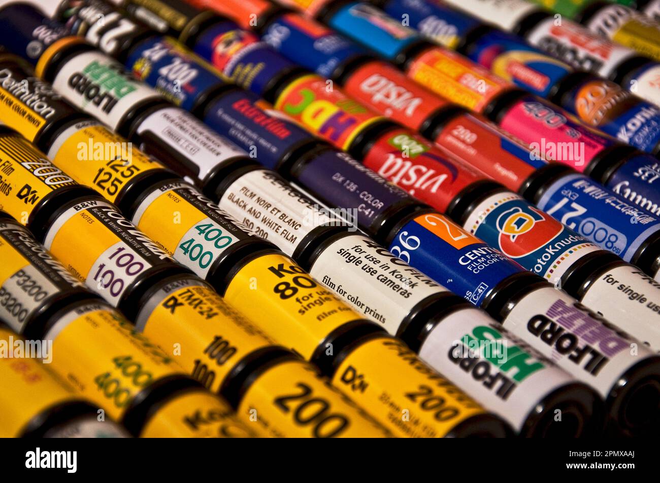 A stack of colorful old school film cartridges Stock Photo