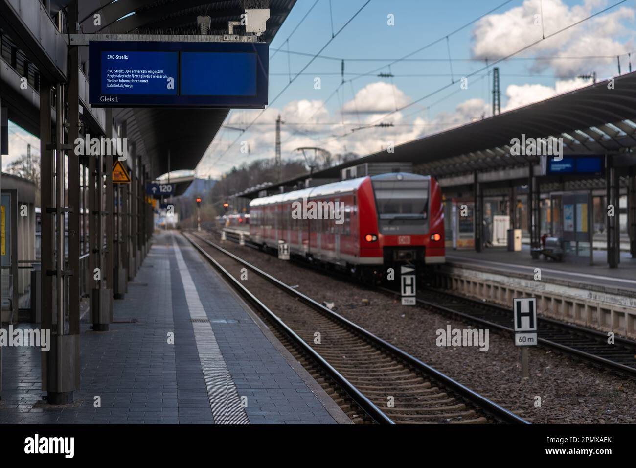 Departure board with EVG strike message and empty railway platform ...