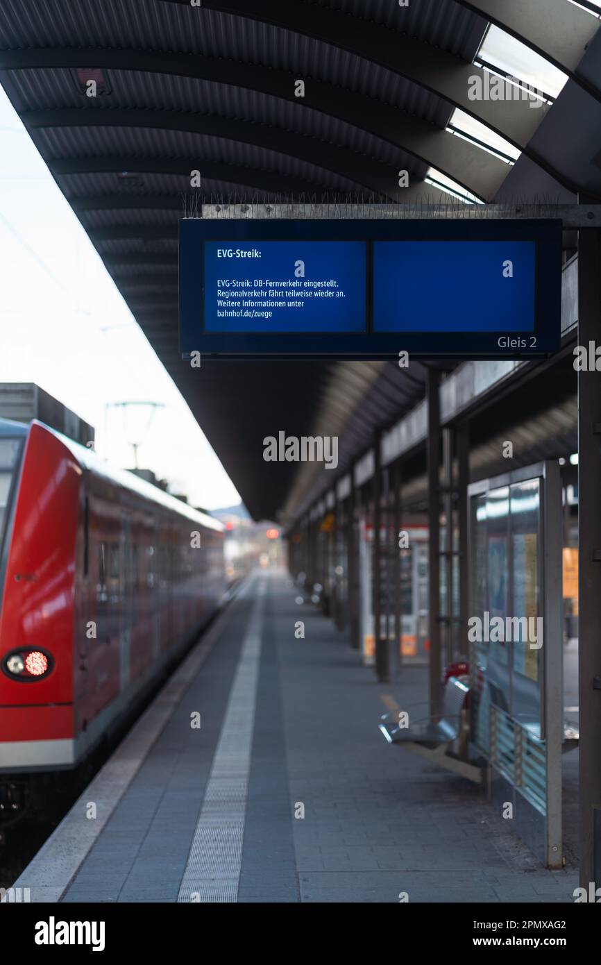 Departure board with EVG strike message, empty train and railway ...