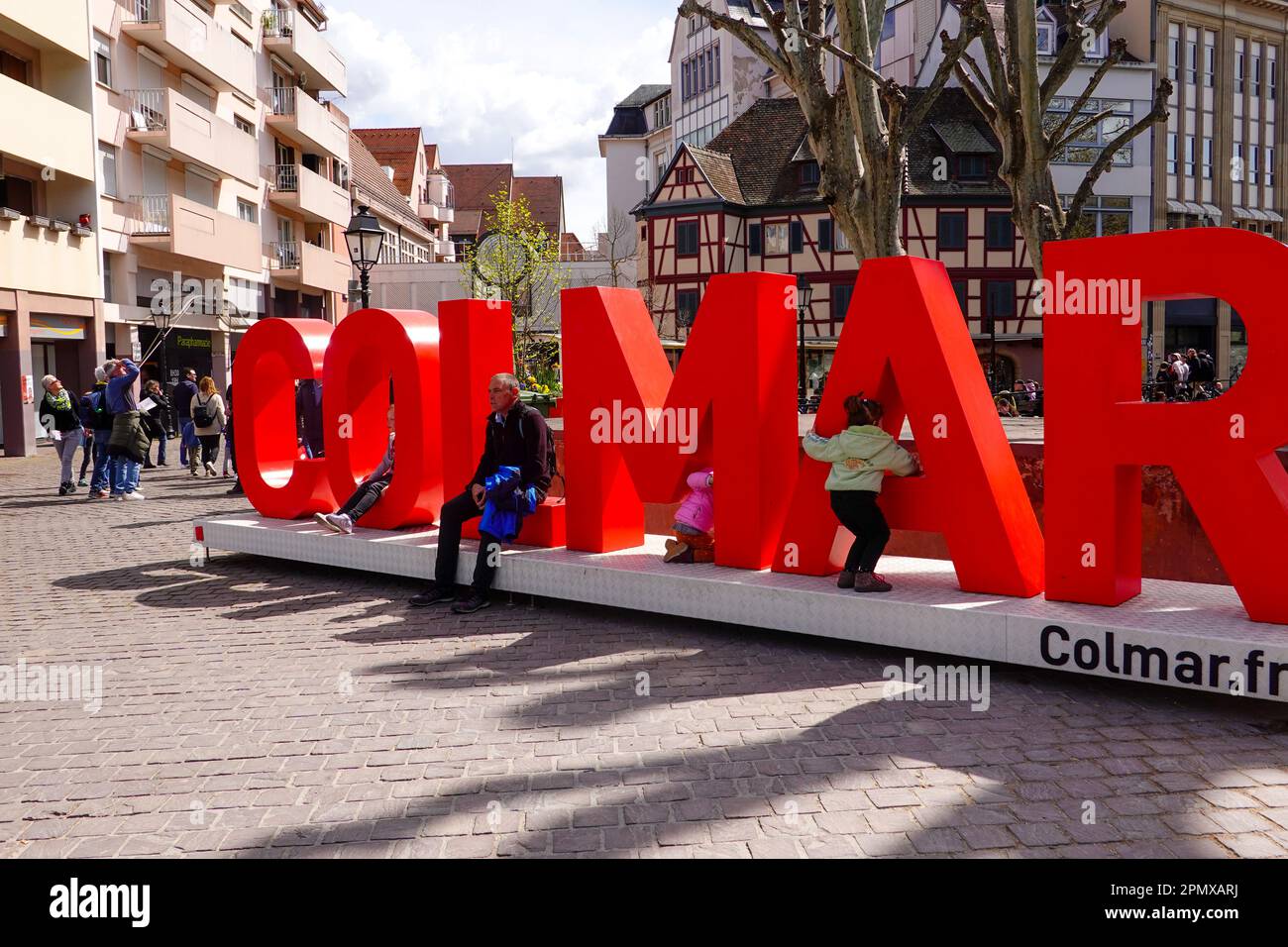 People, children playing, Colmar sign in the heart of the old town