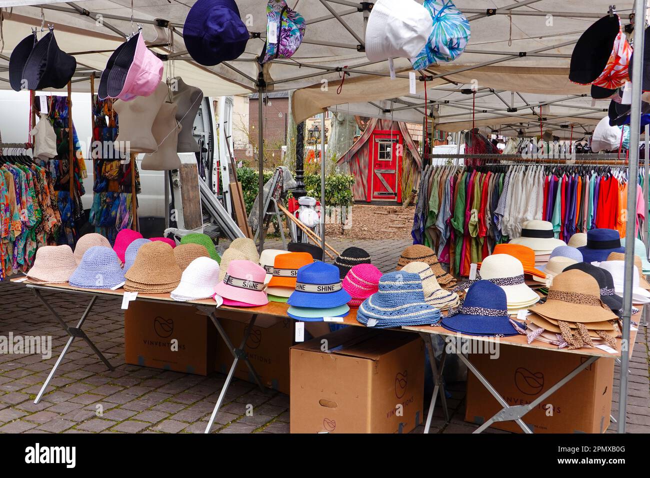 A selection of colourful hats and shirts at the Colmar outdoor market, Alsace, France. Stock Photo