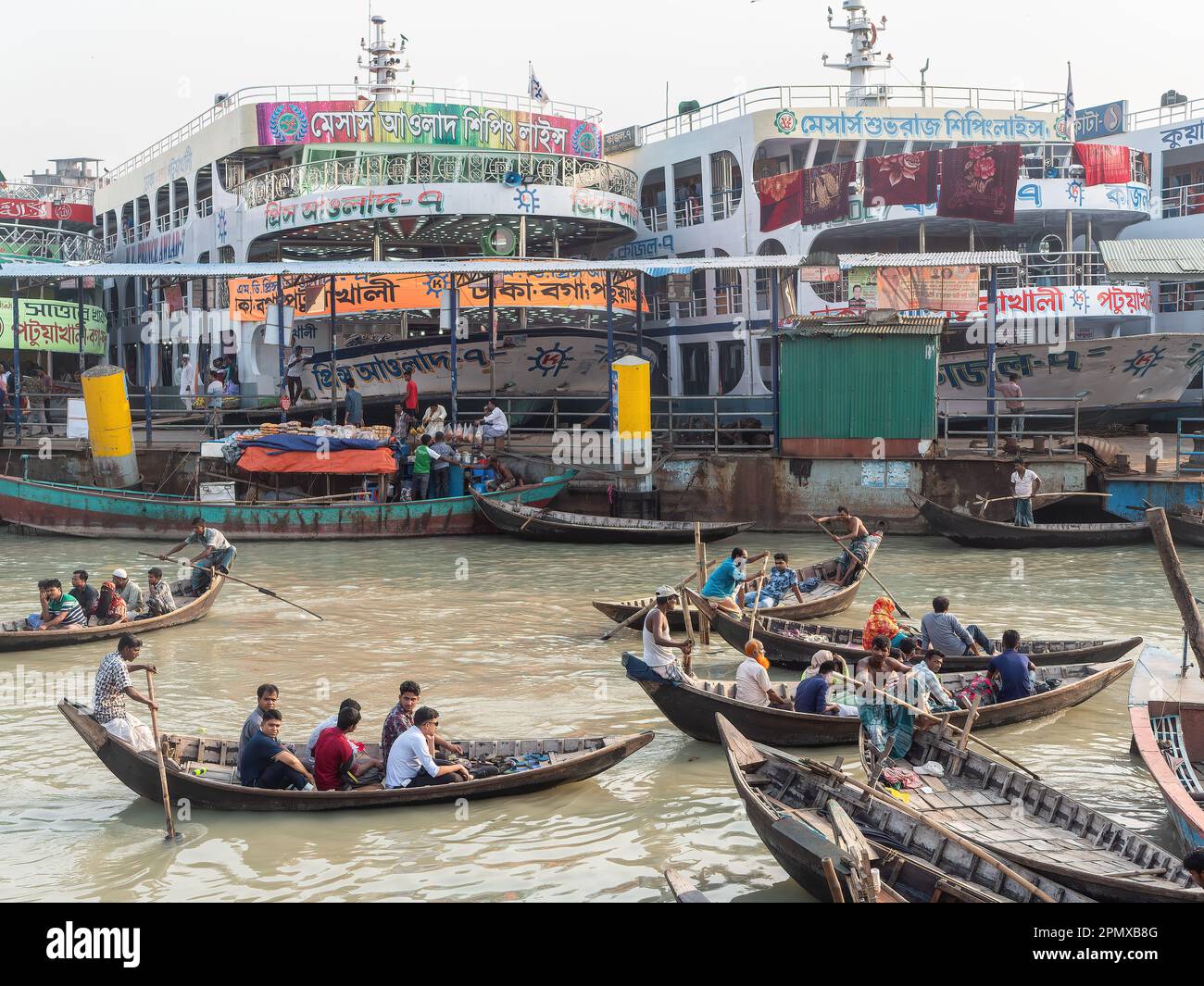 Ferries of different sizes at Wise Ghat Boat Station on Buriganga River in Dhaka, the capital of Bangladesh. Stock Photo