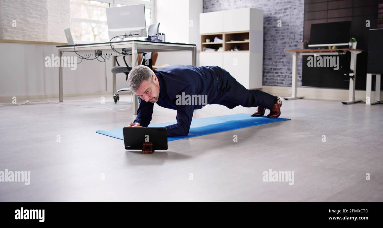 Man Doing Office Plank Exercise Workout Training Stock Photo