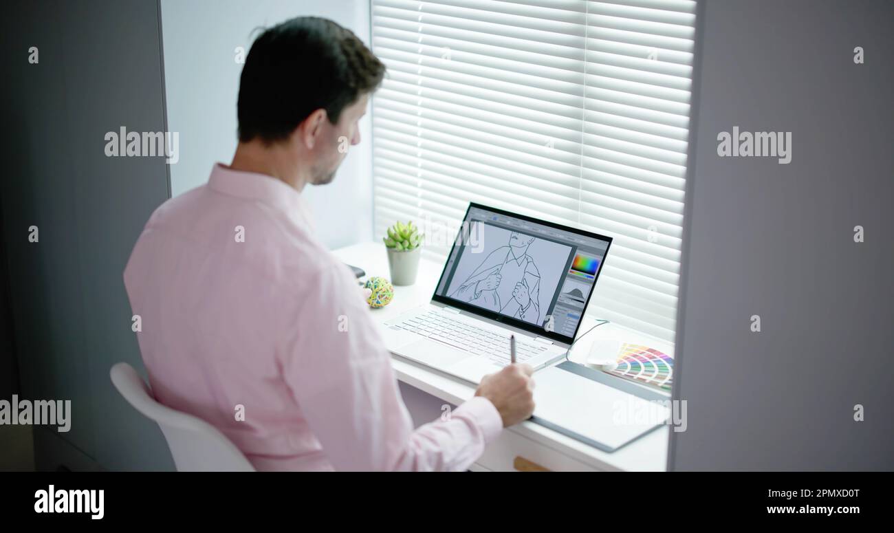 Male Designer Using Graphic Tablet While Working On Computer Stock Photo