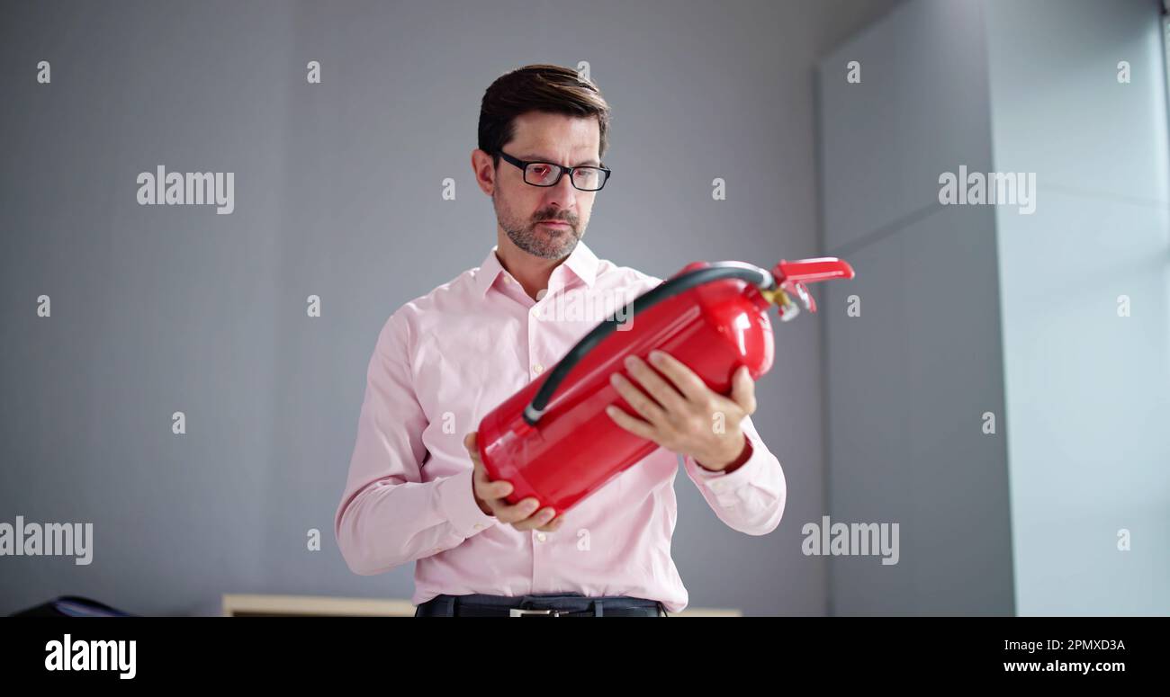 Fire Extinguisher Check At Home. Reading Expiration Date Stock Photo Alamy