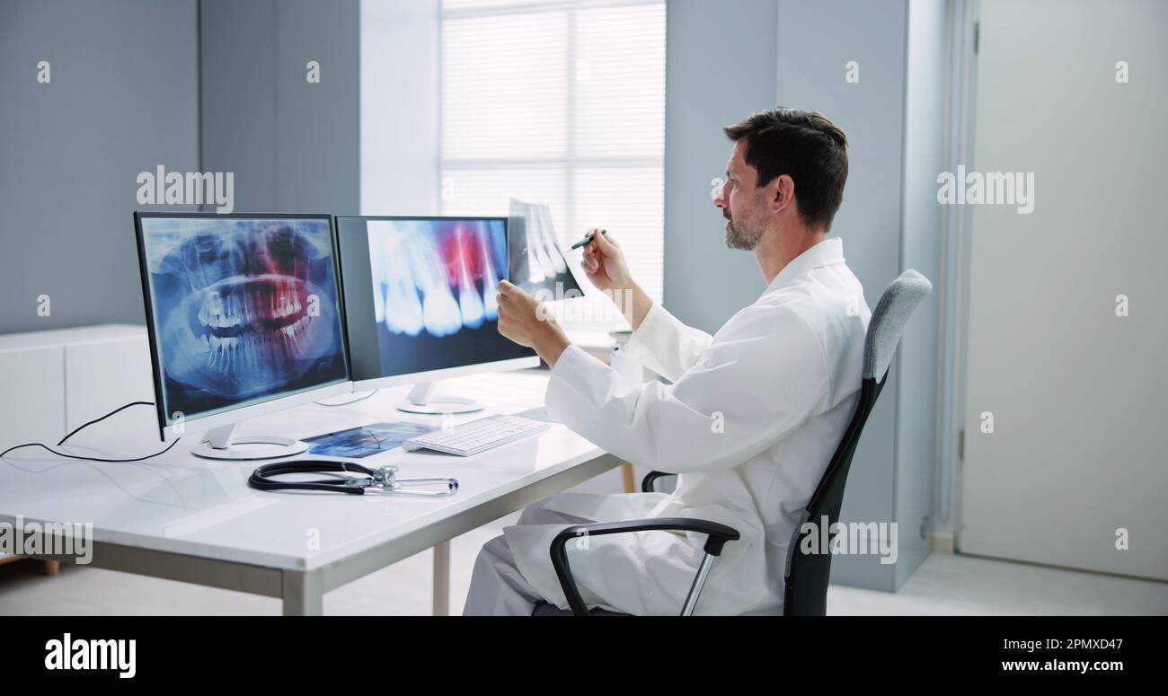 Radiologist Dentist Using X Ray Software On Desktop Computer Stock