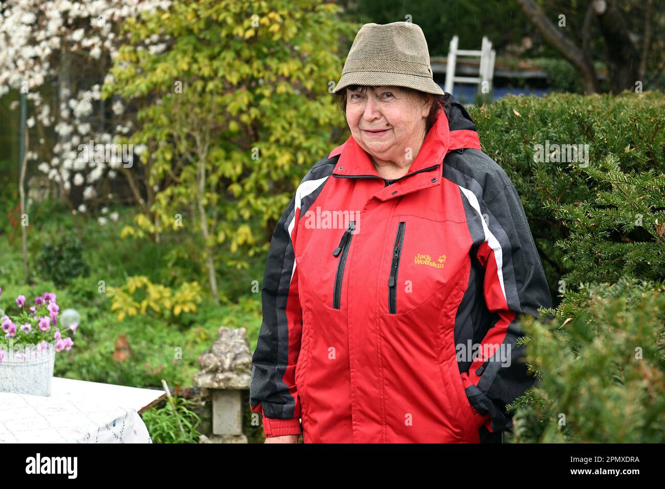 Potsdam, Germany. 15th Apr, 2023. Garden owner Bärbel Metz stands in