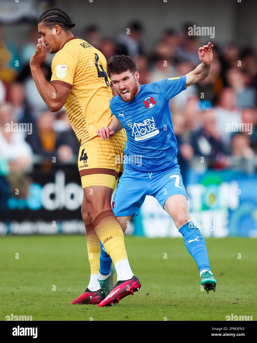 Leyton Orient's Paul Smyth clashes with Sutton United's Coby Rowe during the Sky Bet League Two match at the VBS Community Stadium, Sutton. Picture date: Saturday April 15, 2023. Stock Photo