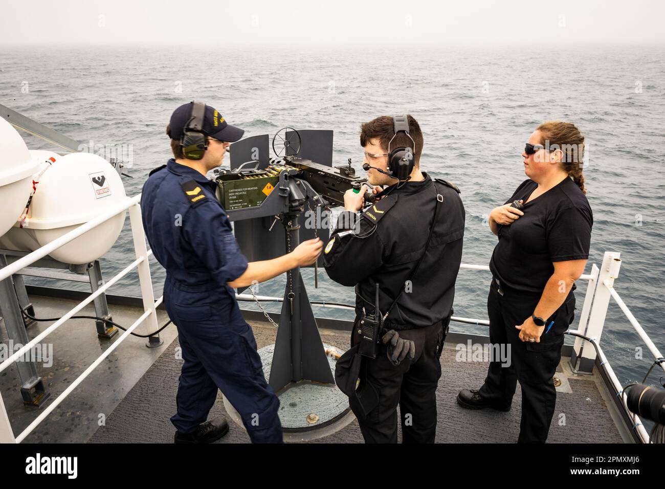 Crew members onboard HMCS Margaret Brooke training at firing a 0.50