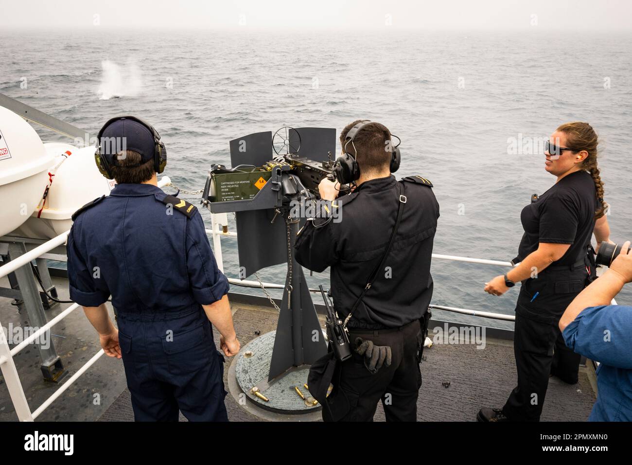 Crew members onboard HMCS Margaret Brooke training at firing a 0.50