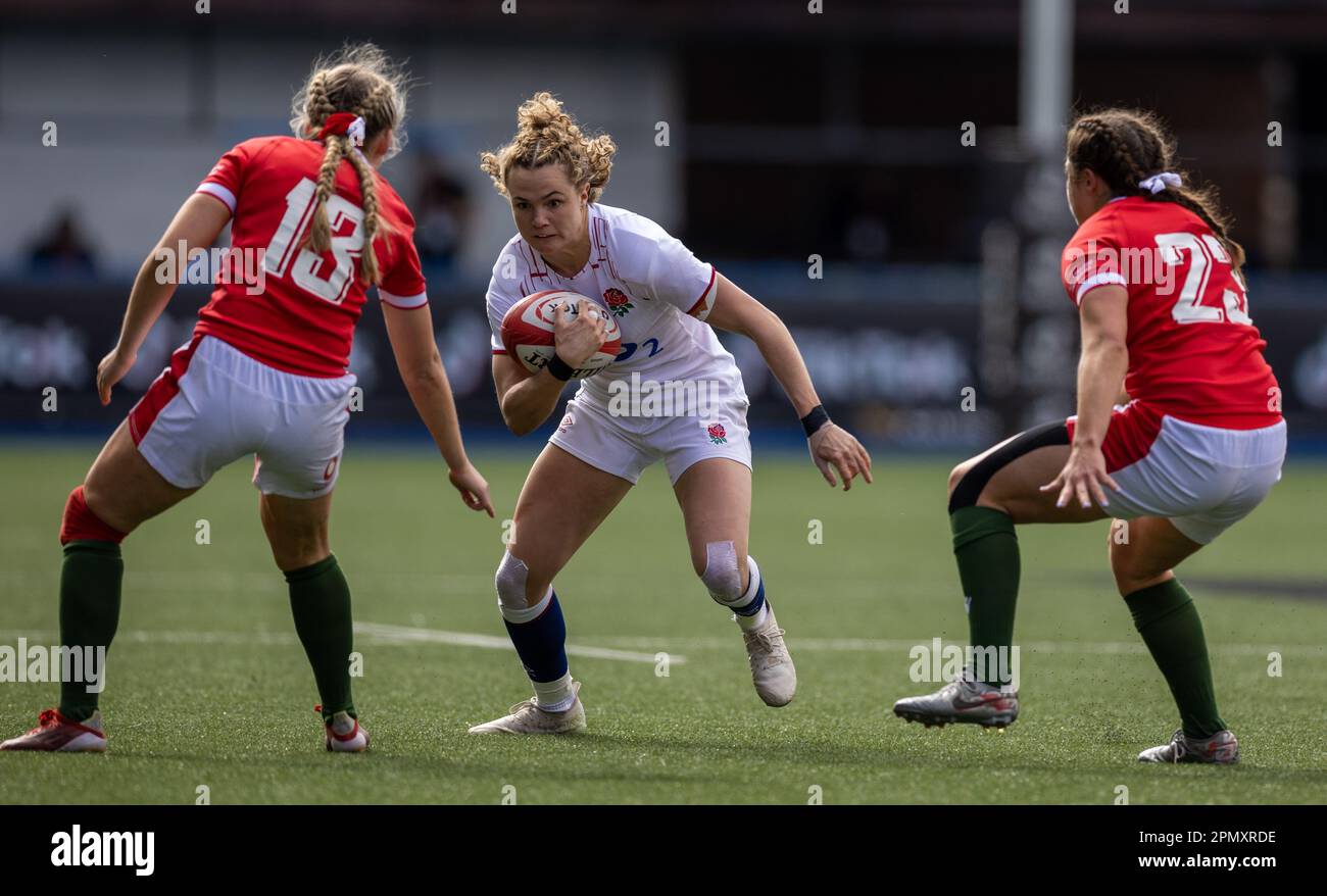 England's Ellie Kildunne is tackled by Wales Hannah Jones (left) and Robyn Wilkins (right) during the third round of the TikTok Women's Six Nations, Cardiff Arms Park, Cardiff. Picture date: Saturday April 15, 2023. Stock Photo