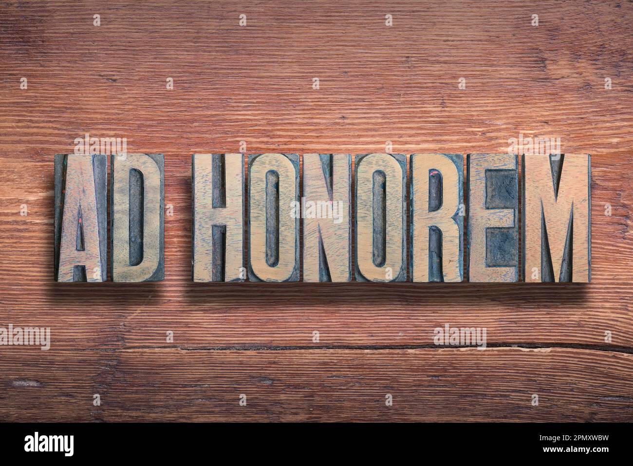 ad honorem ancient Latin saying meaning - to honor, combined on vintage varnished wooden surface Stock Photo