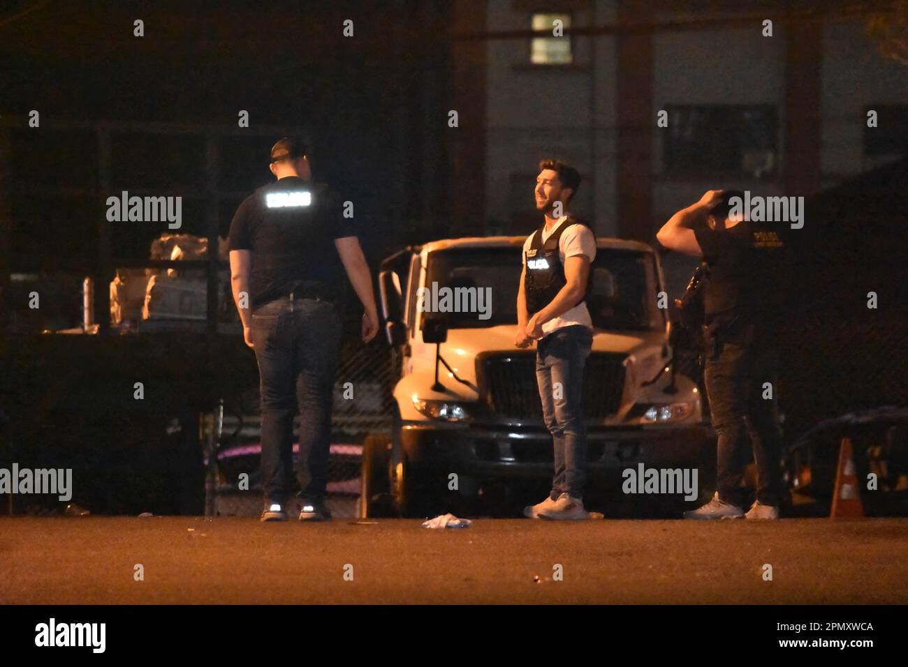 Police officers look for shell casings at the crime scene on Madison ...