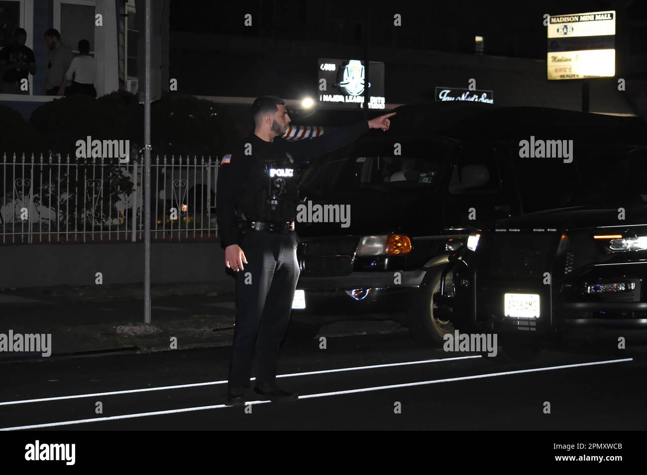 Police officers look for shell casings at the crime scene on Madison ...