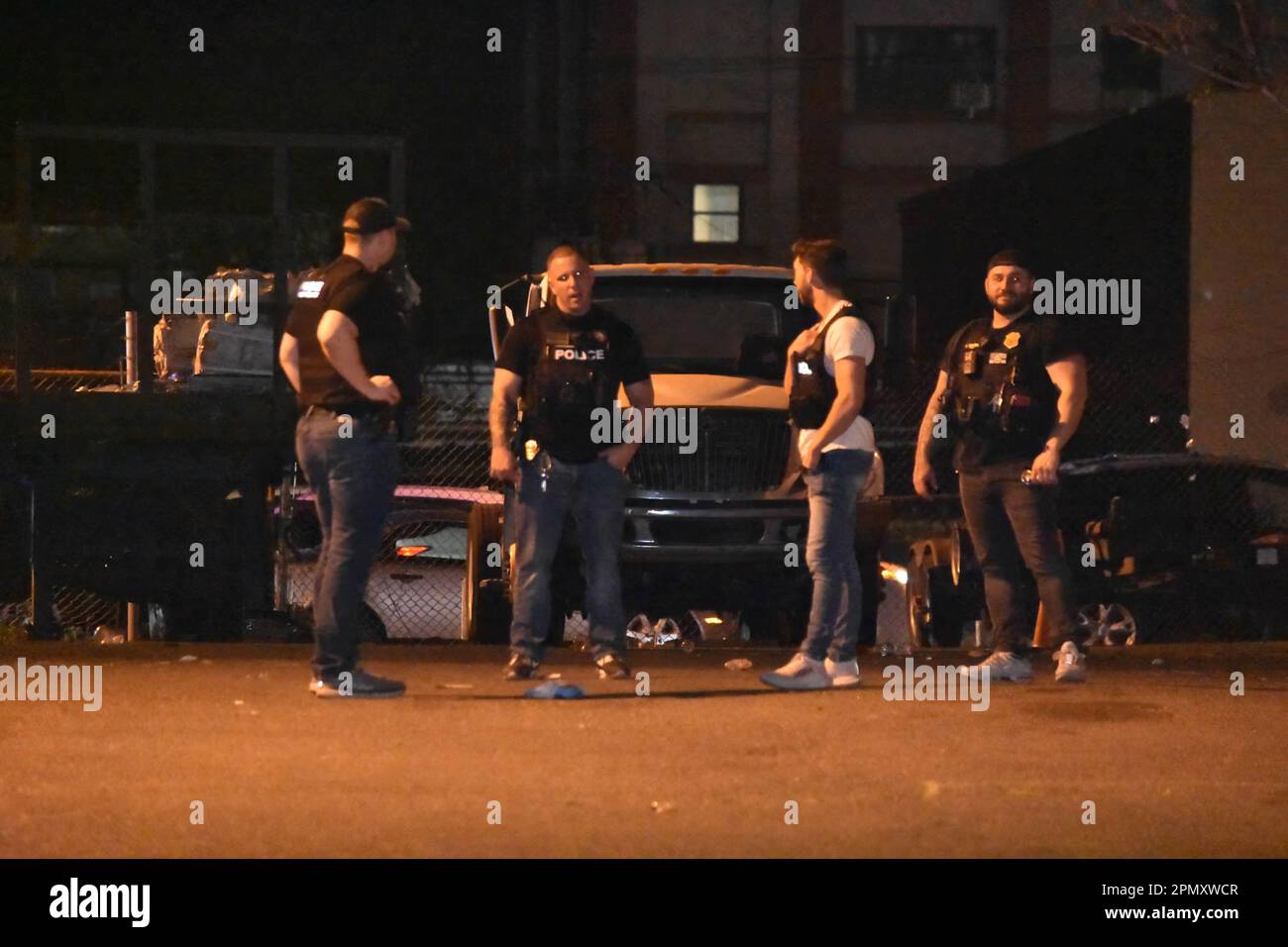 Police officers look for shell casings at the crime scene on Madison ...